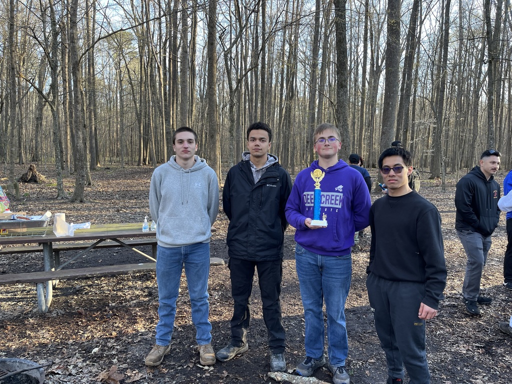 ROTC students at competition holding trophy