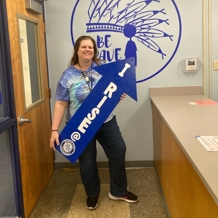 Mrs. Shaughnessy showing off the I RISE arrow