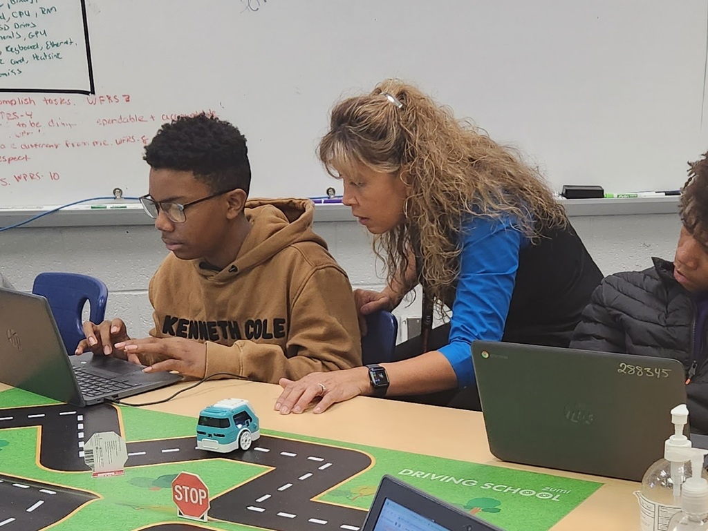 Mrs. Surratt helping a student on the computer