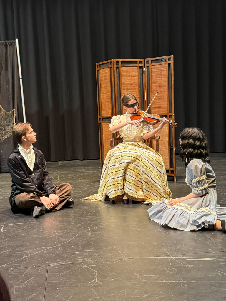 drama students in character on stage