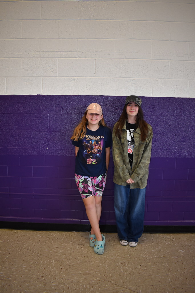 Two students wearing a their favorite hats for spirit month