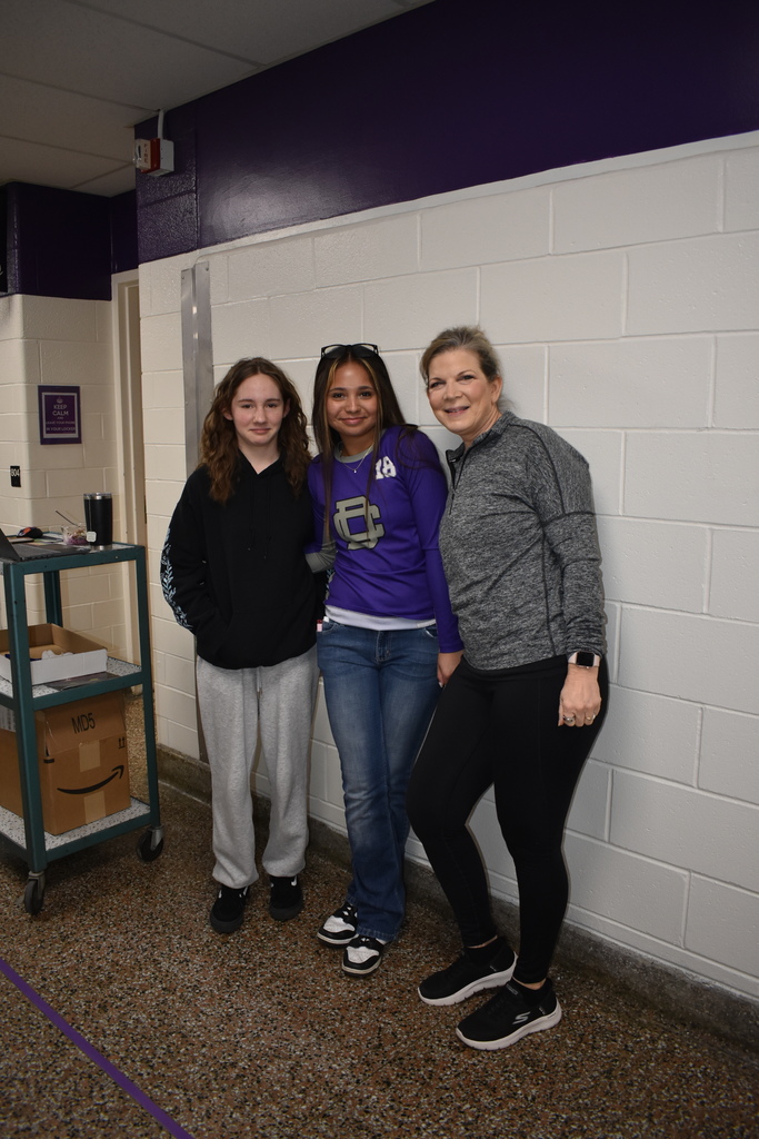 a teacher and two students wearing a their athletic gear