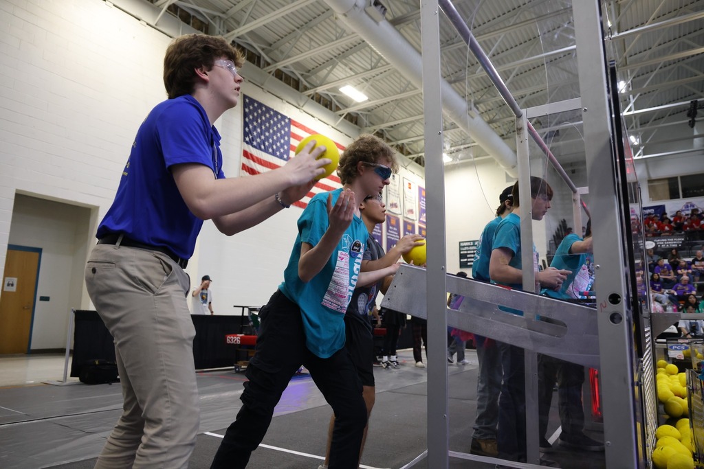 The HHS Robotics team working together during the competition.