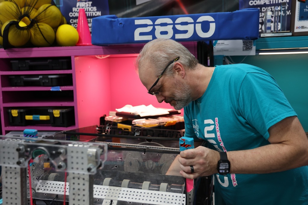 Teacher Chris Slater looking at the robot.