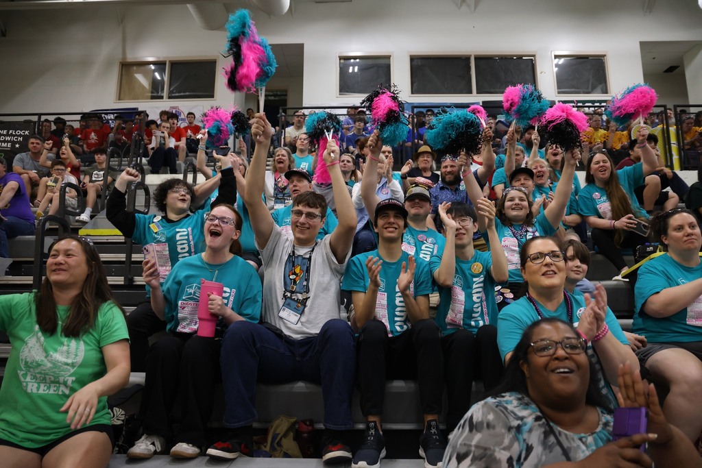Supporters of the team in the crowd celebrating.