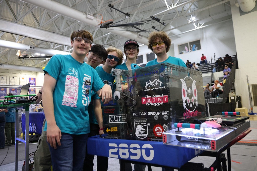 The HHS Robotics team smiling together with their robot!