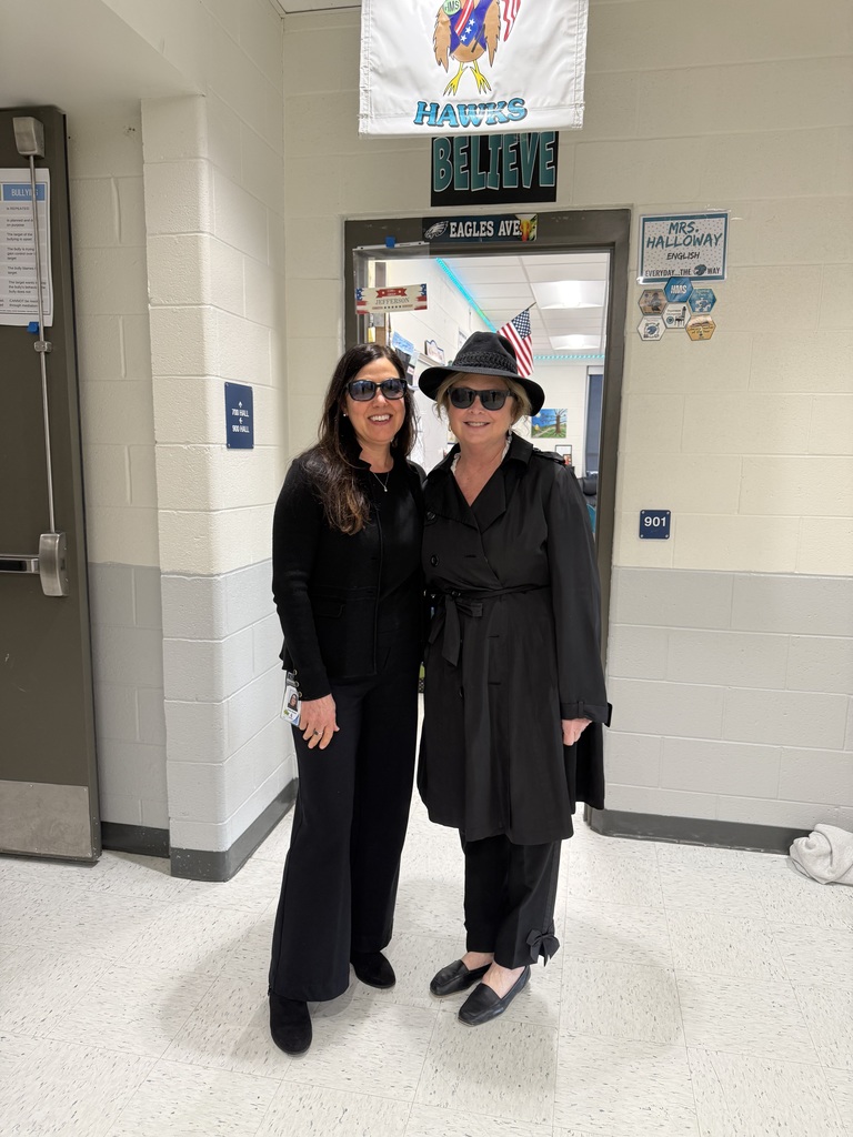 two teachers dressed in all black as secret agents