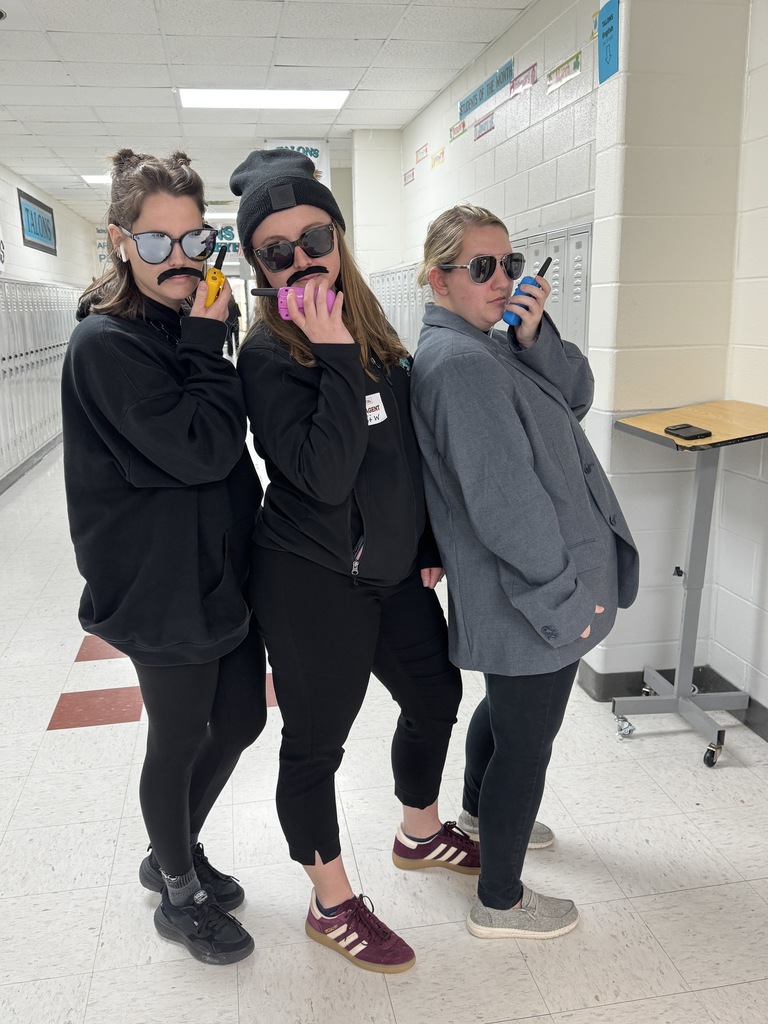 teachers dressed as secret agents with walkie talkies and sunglasses