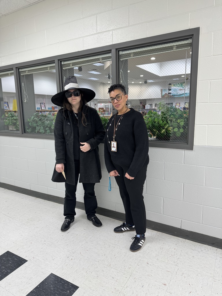 Two educators dressed as secret agents