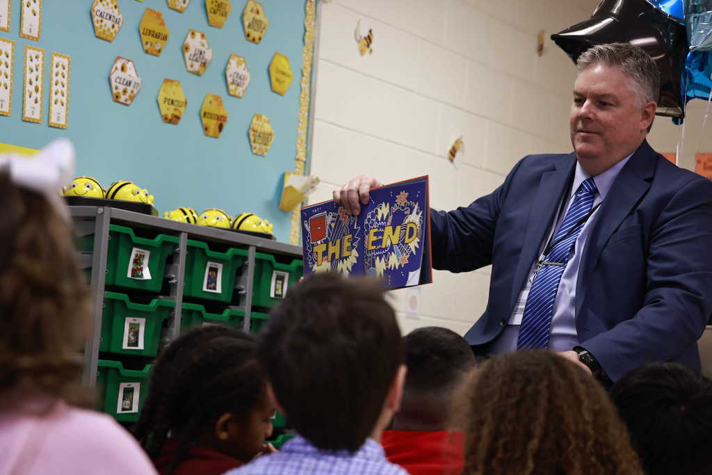 Dr. Cotton shows an illustration at the end of his book to the students.