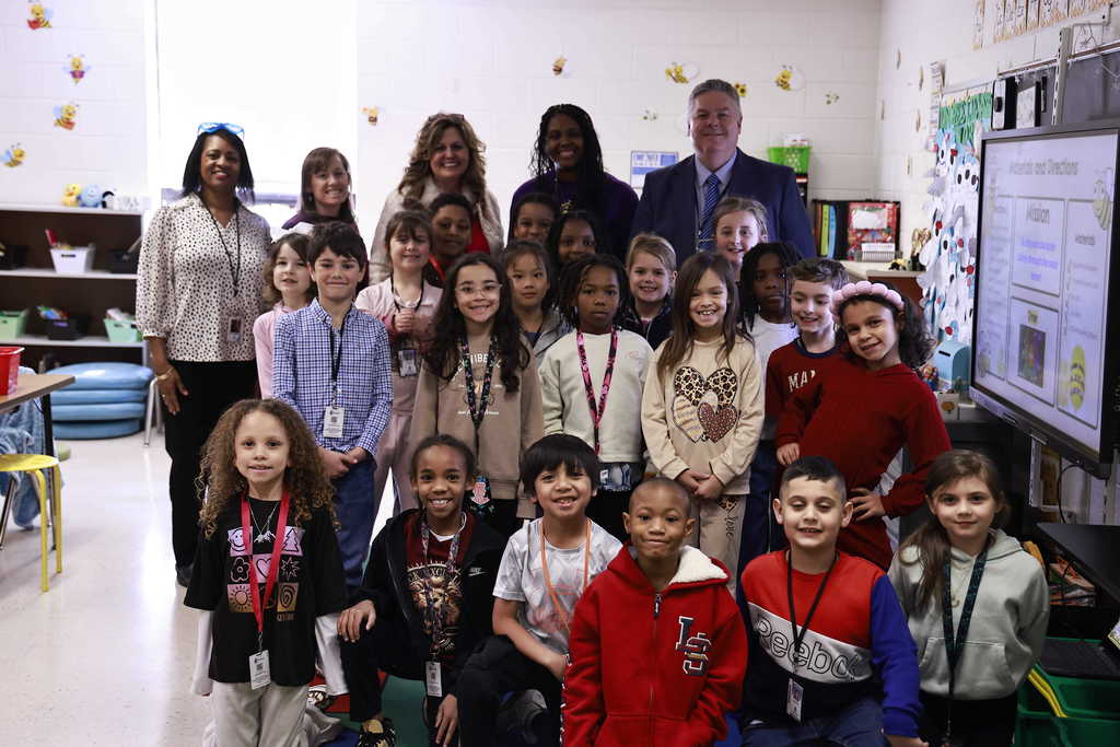Ms. Stachell's class, Dr. Cotton and the GRP Principal take a group picture