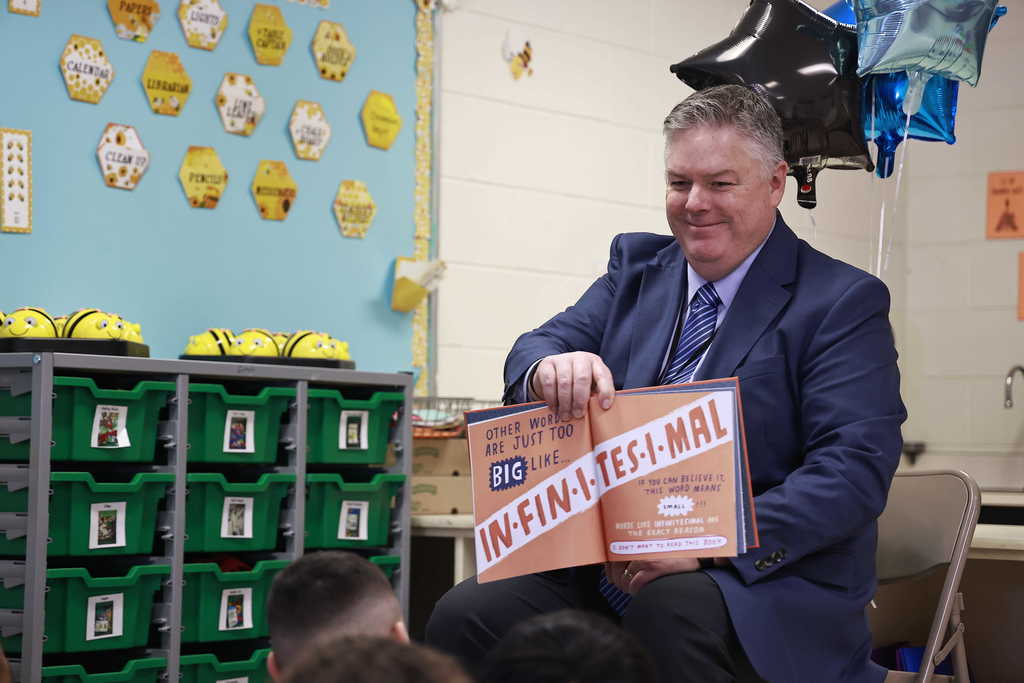 Dr. Cotton shows an illustration from his book to the students.