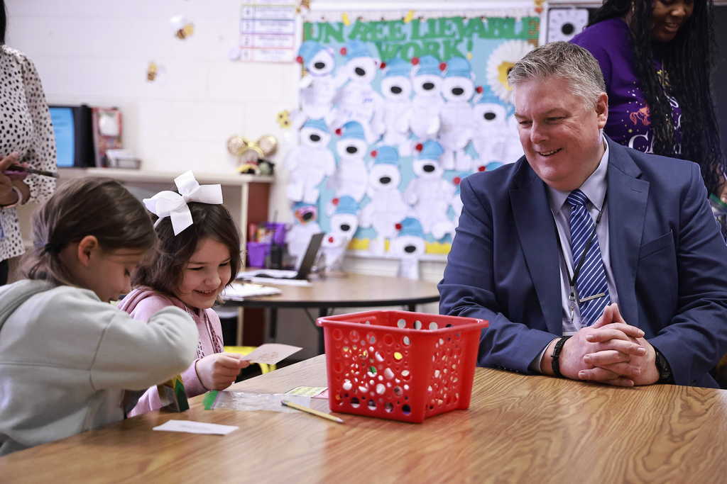 Dr. Cotton watches two students complete an assignment together