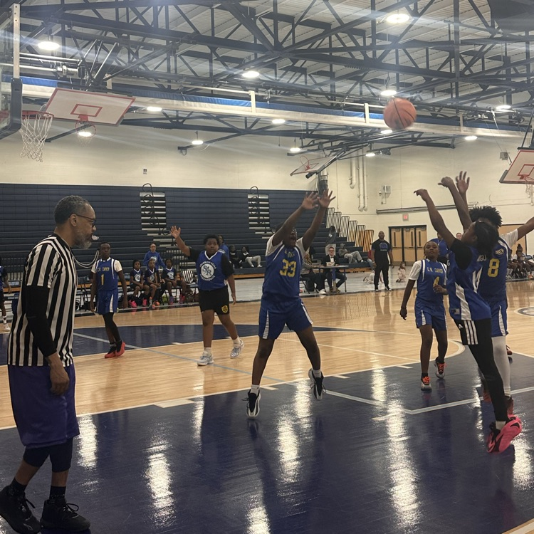 Basketball teams trying to score and block. 