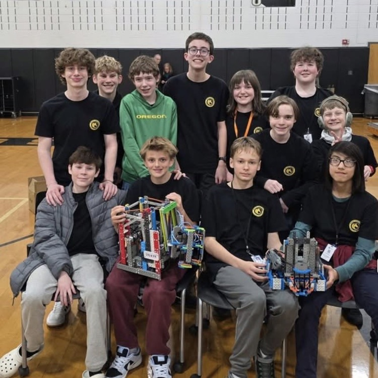 Hugo Owens students at robotics championship, smiling holding trophy