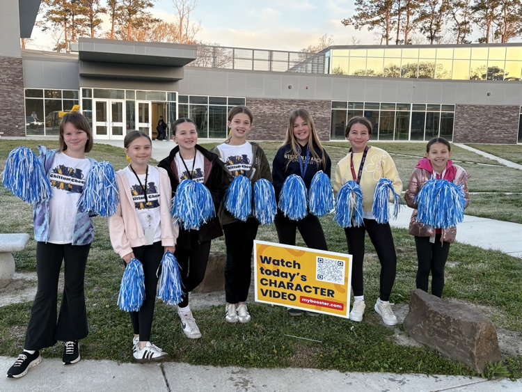 Students excited to kick off this years Boosterthon standing outside of the school with pompoms! 