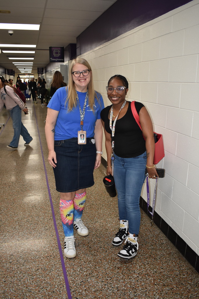 Two teachers showing off her fun socks