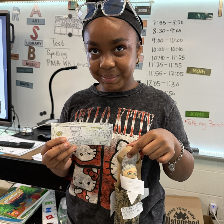 Student showing off their Presidential Action figure. 