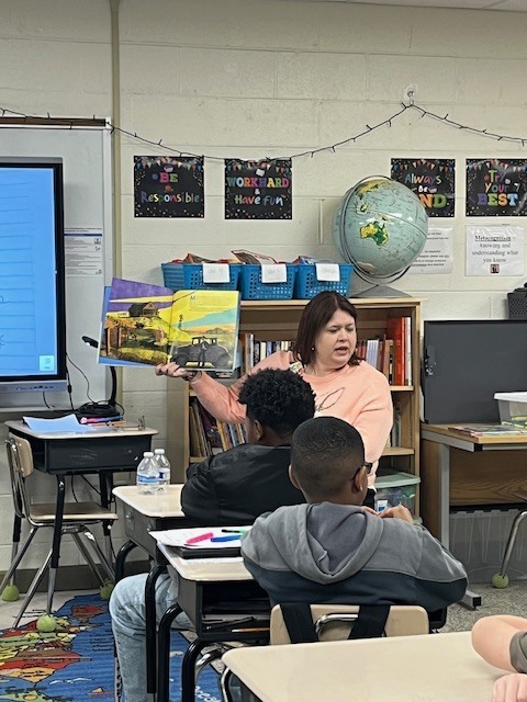 Students listening to a guest reader to spread the joy of reading!