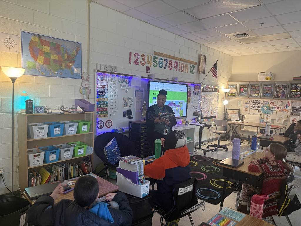 Students listening to a guest reader to spread the joy of reading!