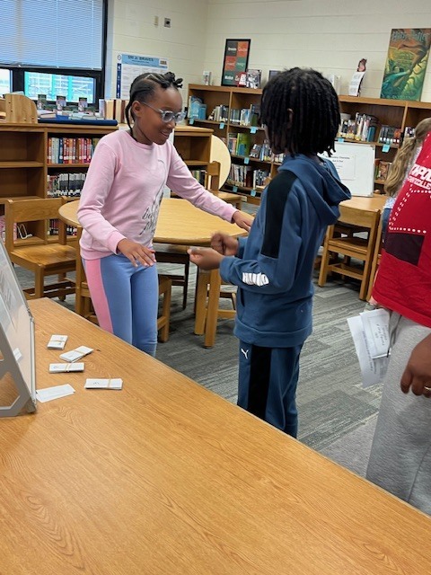 Students excitedly working together to play Vocabulary in Motion!