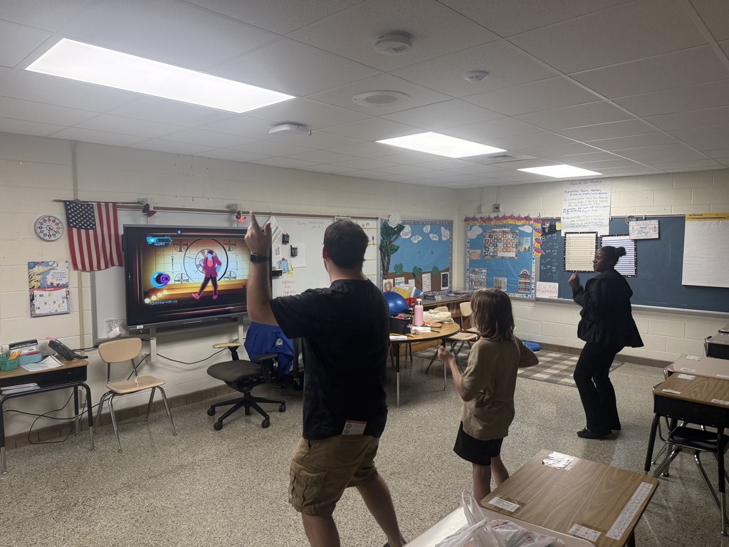 Parent, student, and staff dancing with Go Noodle!