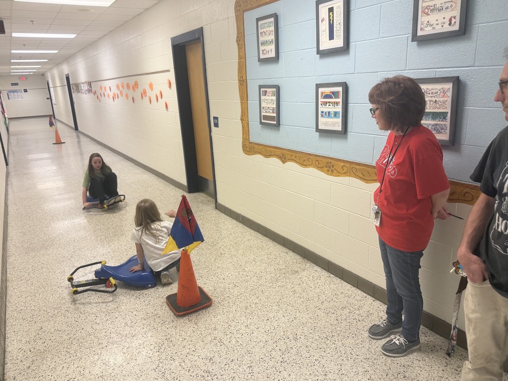 Students focused on using their scooters to complete the obstacle.