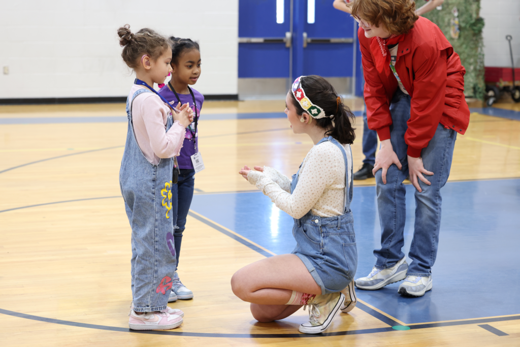 students practice sign language with gfh performers they are intently practicing