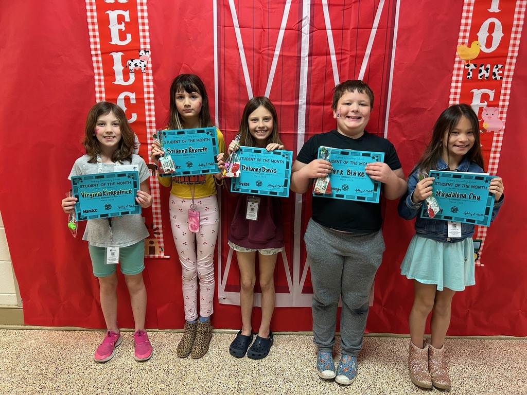 Third grade students holding their student of the month awards