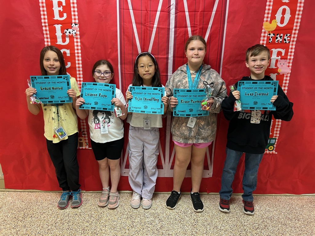 fourth grade students holding their student of the month awards