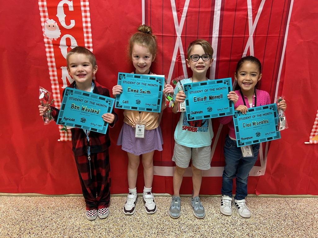 kindergarten students holding their student of the month awards