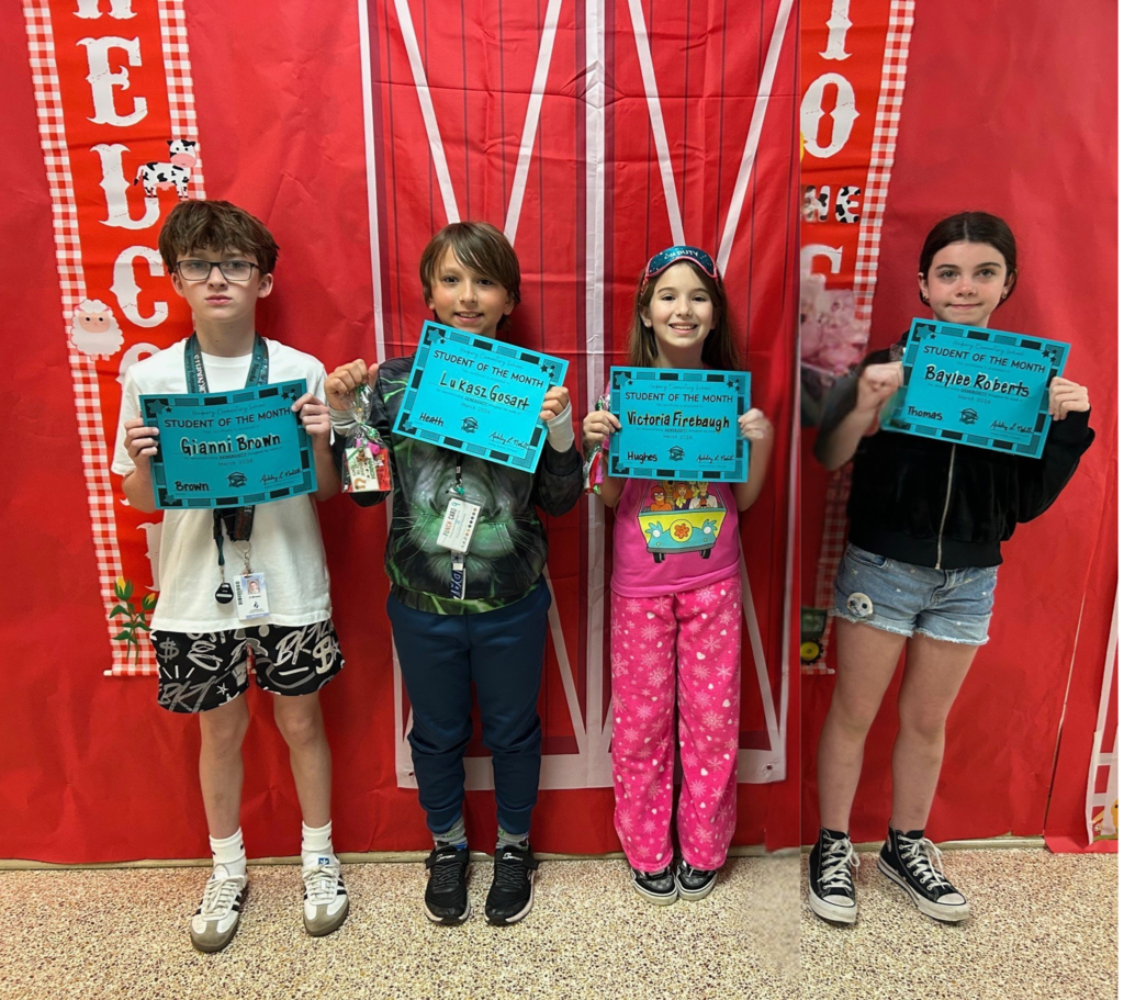 fifth grade students holding their student of the month awards