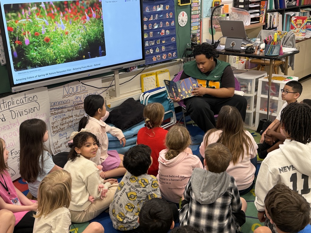 Football player reading to class