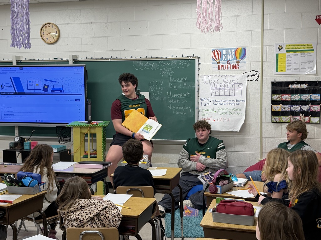 Football player reading to class