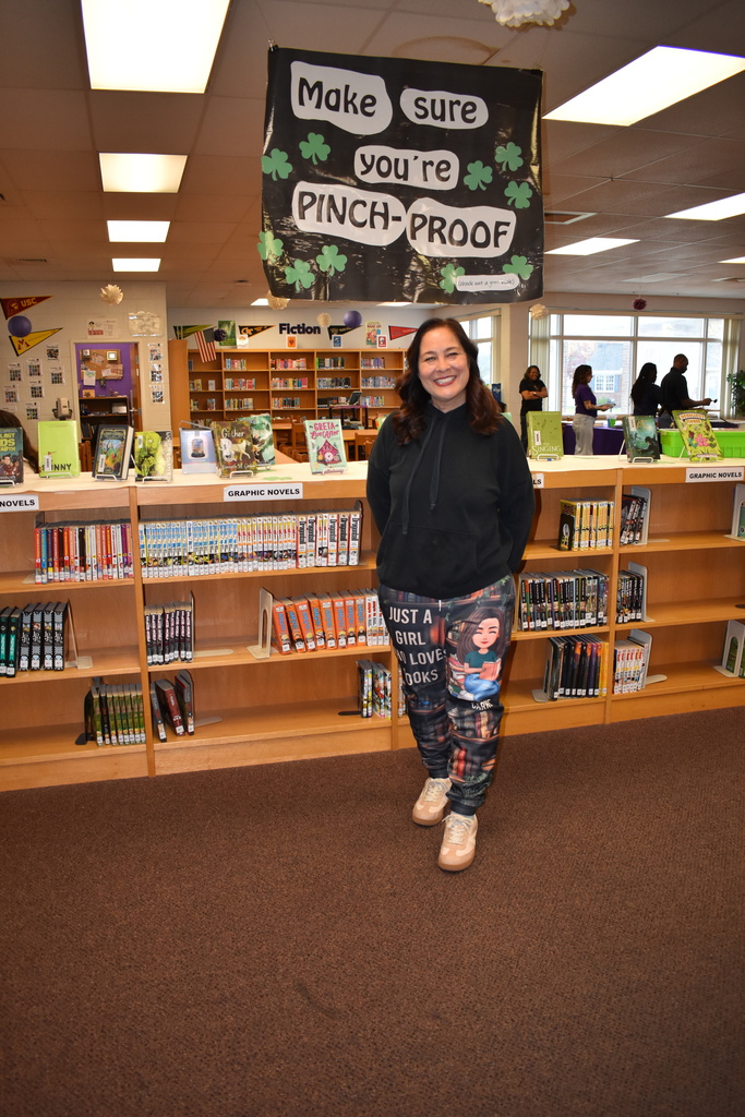 OUr librarian in her book pajamas enjoying reading month pajama day!