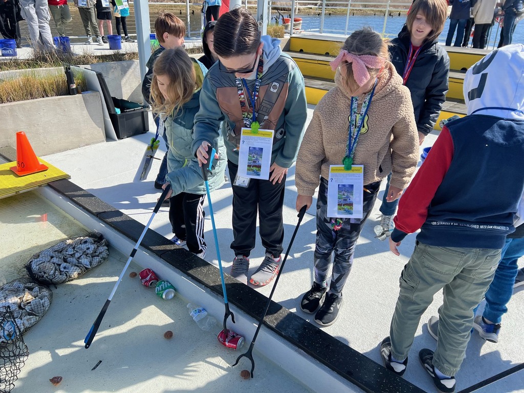 students picking up trash to learn about cleaning up our local waters