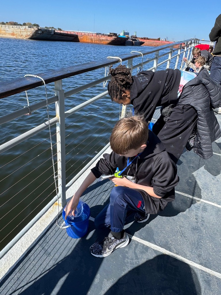 students testing the water on the learning barge
