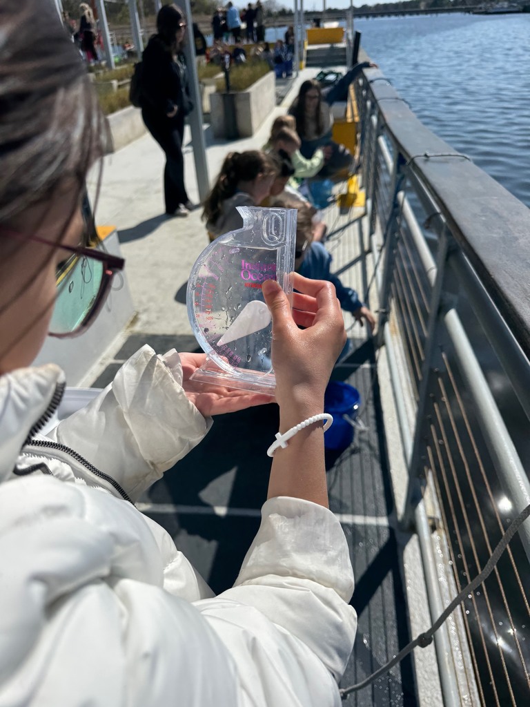students testing water on the learning barge 
