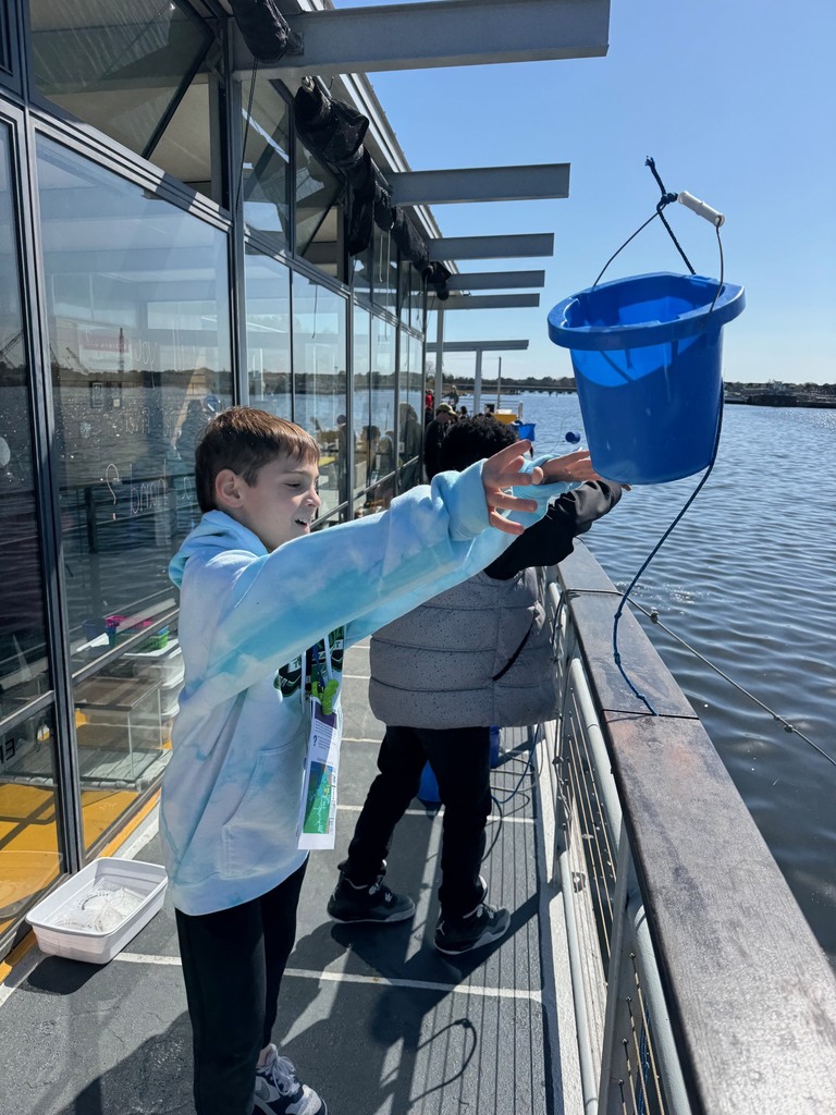 students testing the water on the learning barge