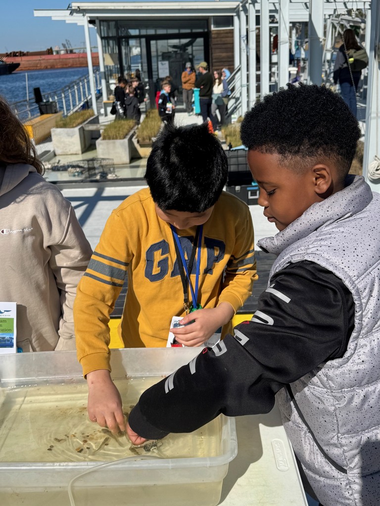 students testing exploring the water in the learning barge 
