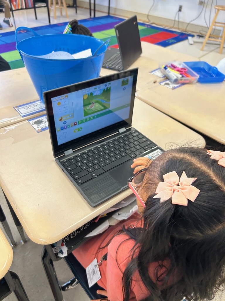first grade students using scratchjr to code about flowers