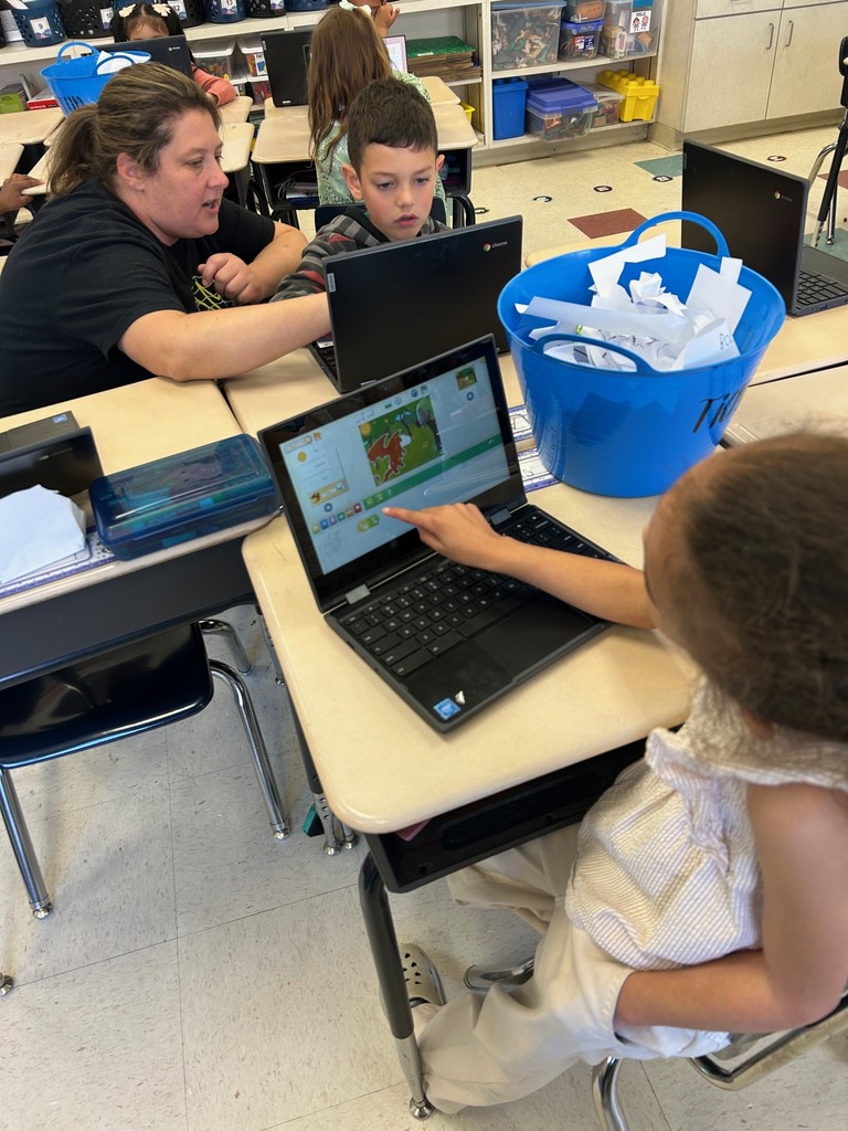 first grade students using scratchjr to code about flowers