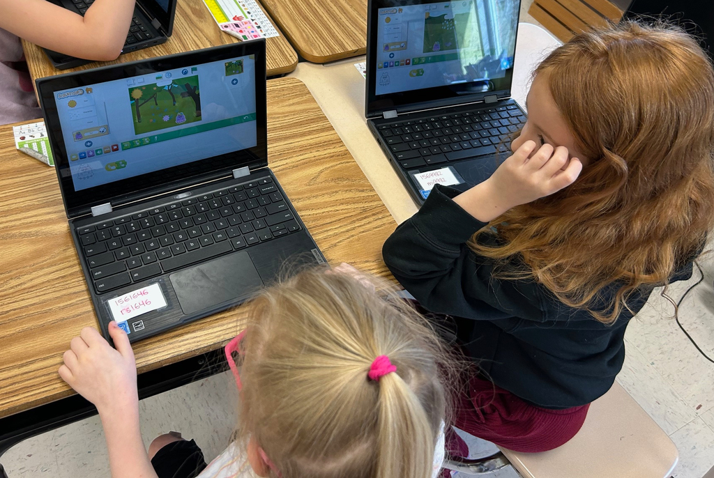 first grade students using scratchjr to code about flowers