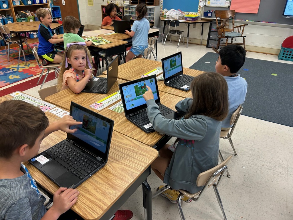 first grade students using scratchjr to code about flowers
