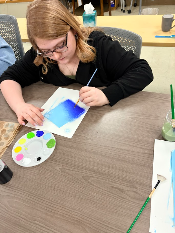 Student painting to relieve stress