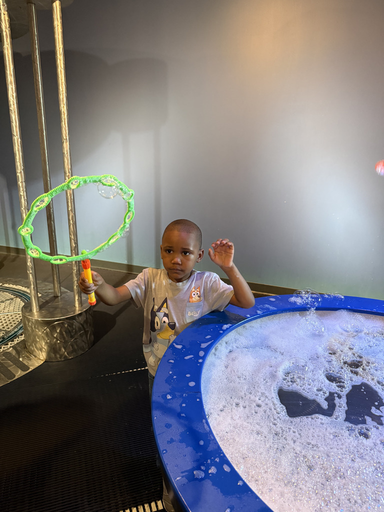 Student playing with bubble wand