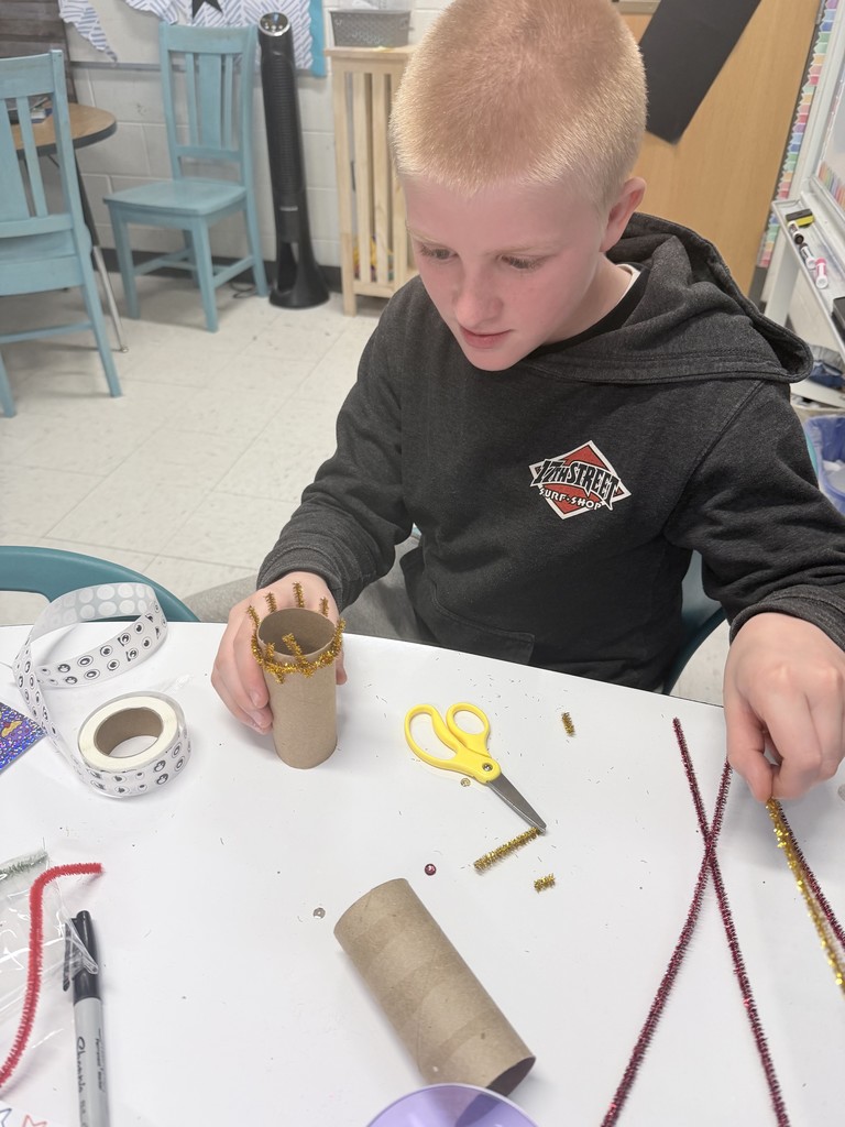 A student creating a plan for the materials on his desk 