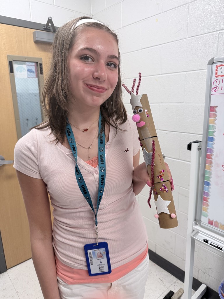 student posing with her hand made creation