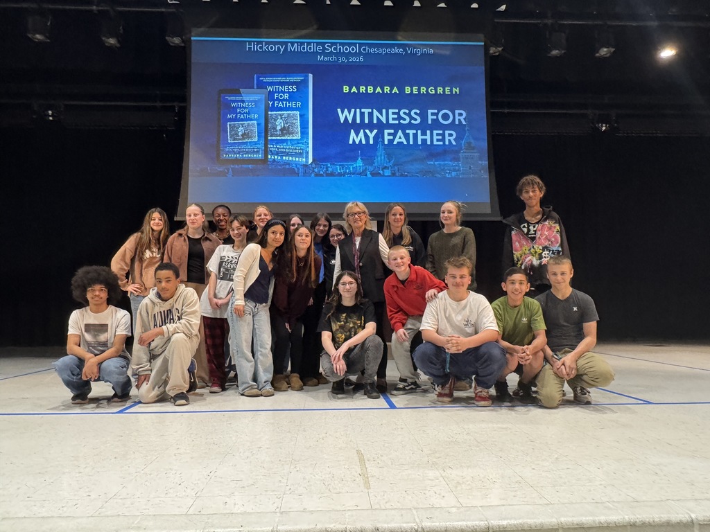 A group of students smiling and posing proudly with our guest speaker
