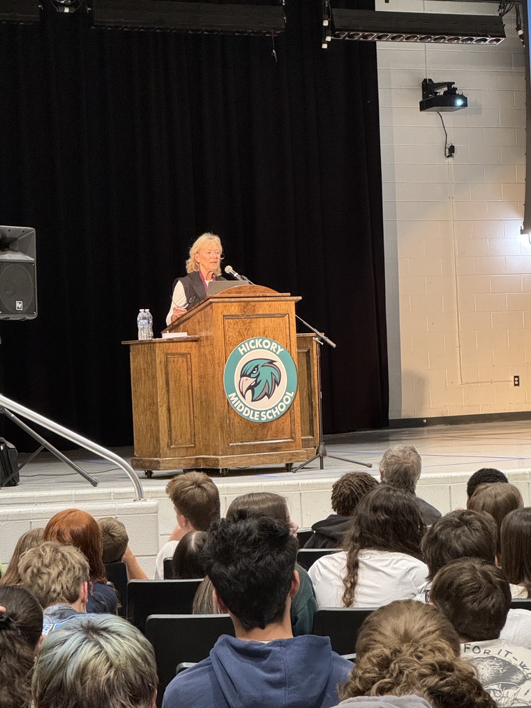 Guest Speaker at the podium delivering encouragement to our young students